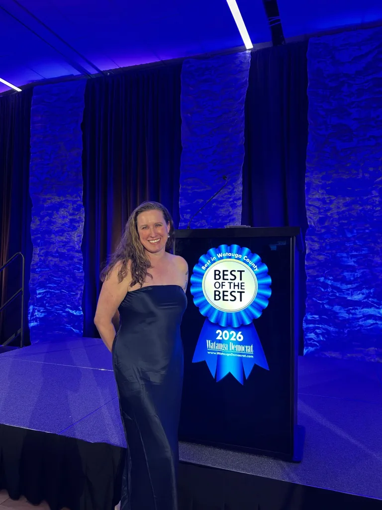 Dr. Tracy Parrish beside the Best of the Best 2026 ribbon at the Watauga Democrat awards